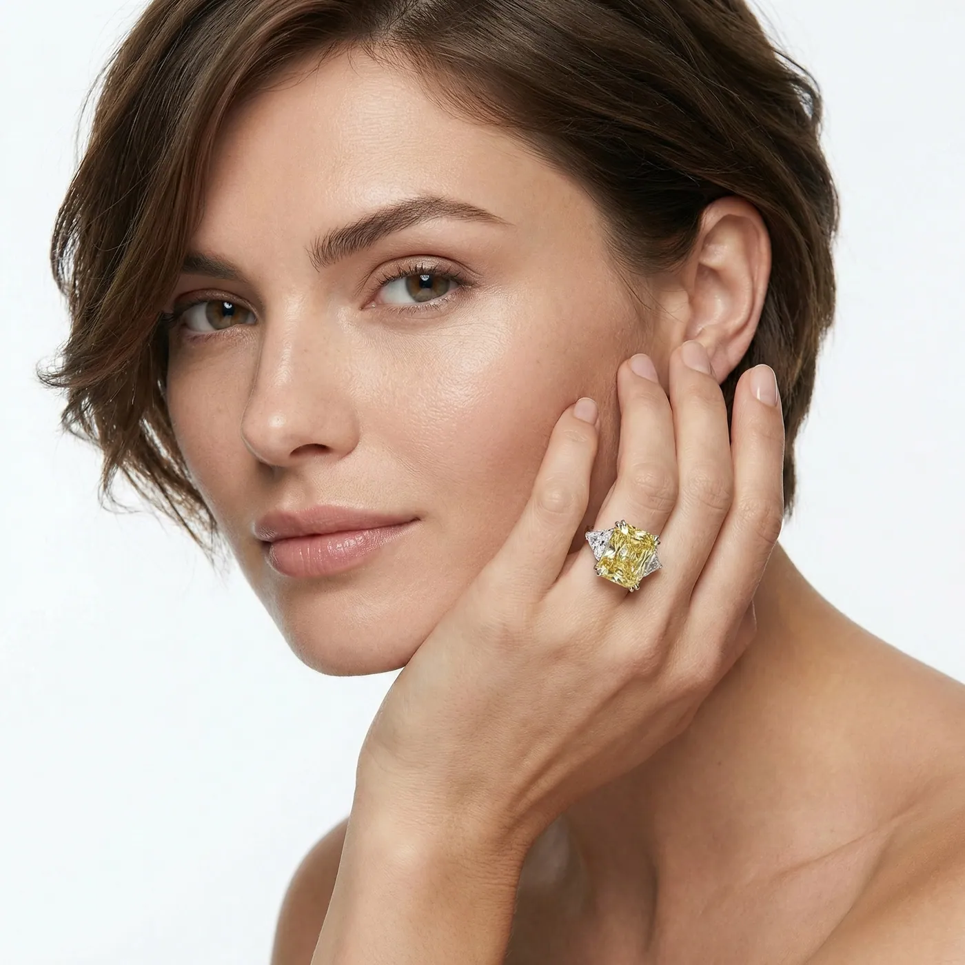 Model wearing a Sirius ring with a yellow diamond
